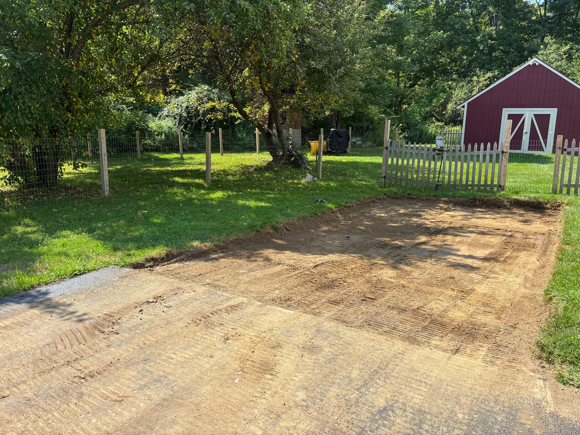 Sod and topsoil stripped off the marked area with the subgrade leveled and ready for stone