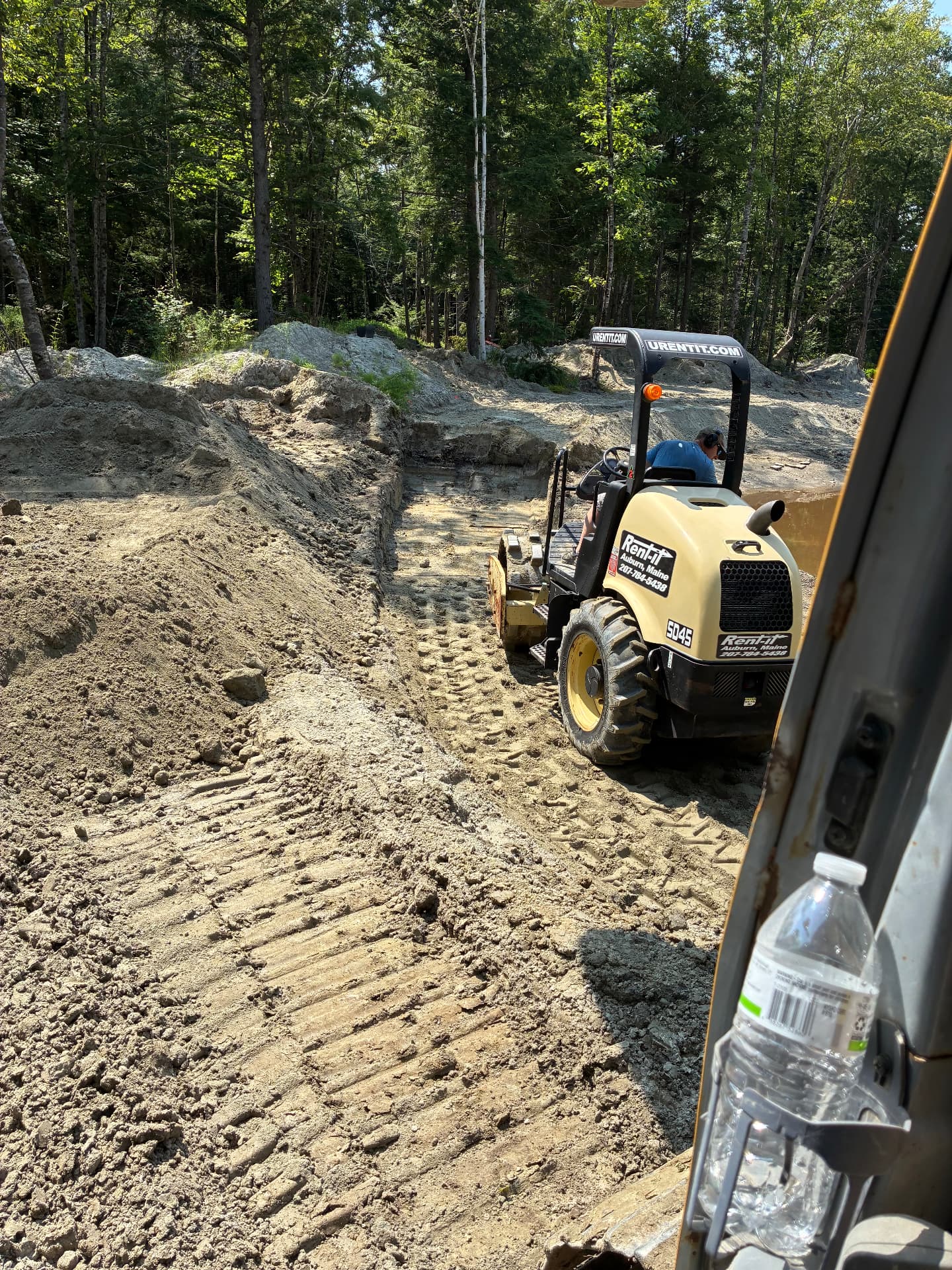 Compacting the base of the trench for the pond outlet pipe