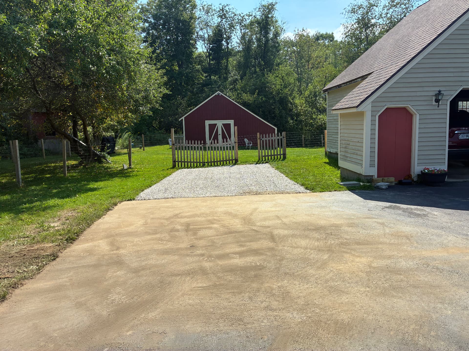 Finished crushed-stone parking pad tied into the existing driveway at a Maine home