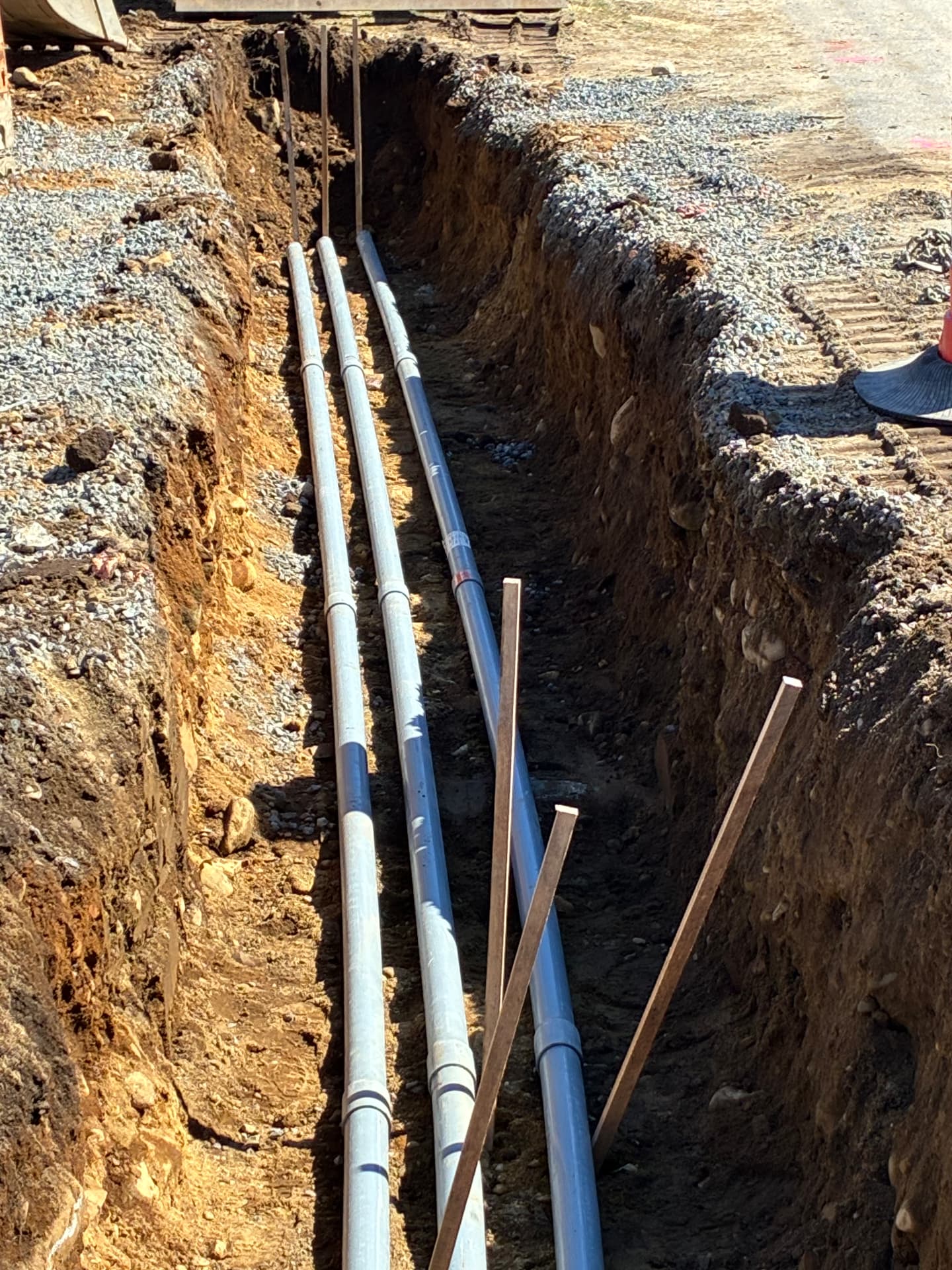 Utility trench with three conduit runs installed